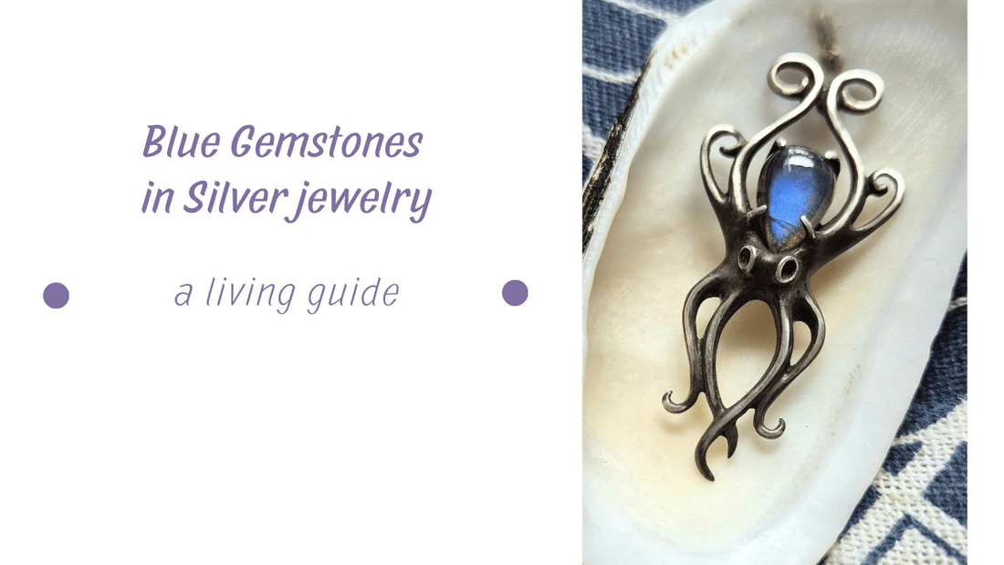 Blue Gemstones - Silver Octopus necklace with a blue labradorite, shown inside a white seashell with indigo textile background