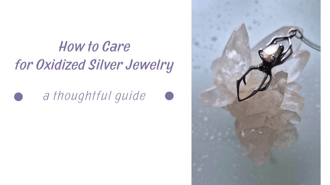 Jewelry care - Close-up of oxidized silver spider pendant with a soft pinkish golden gemstone, resting on a clear crystal cluster