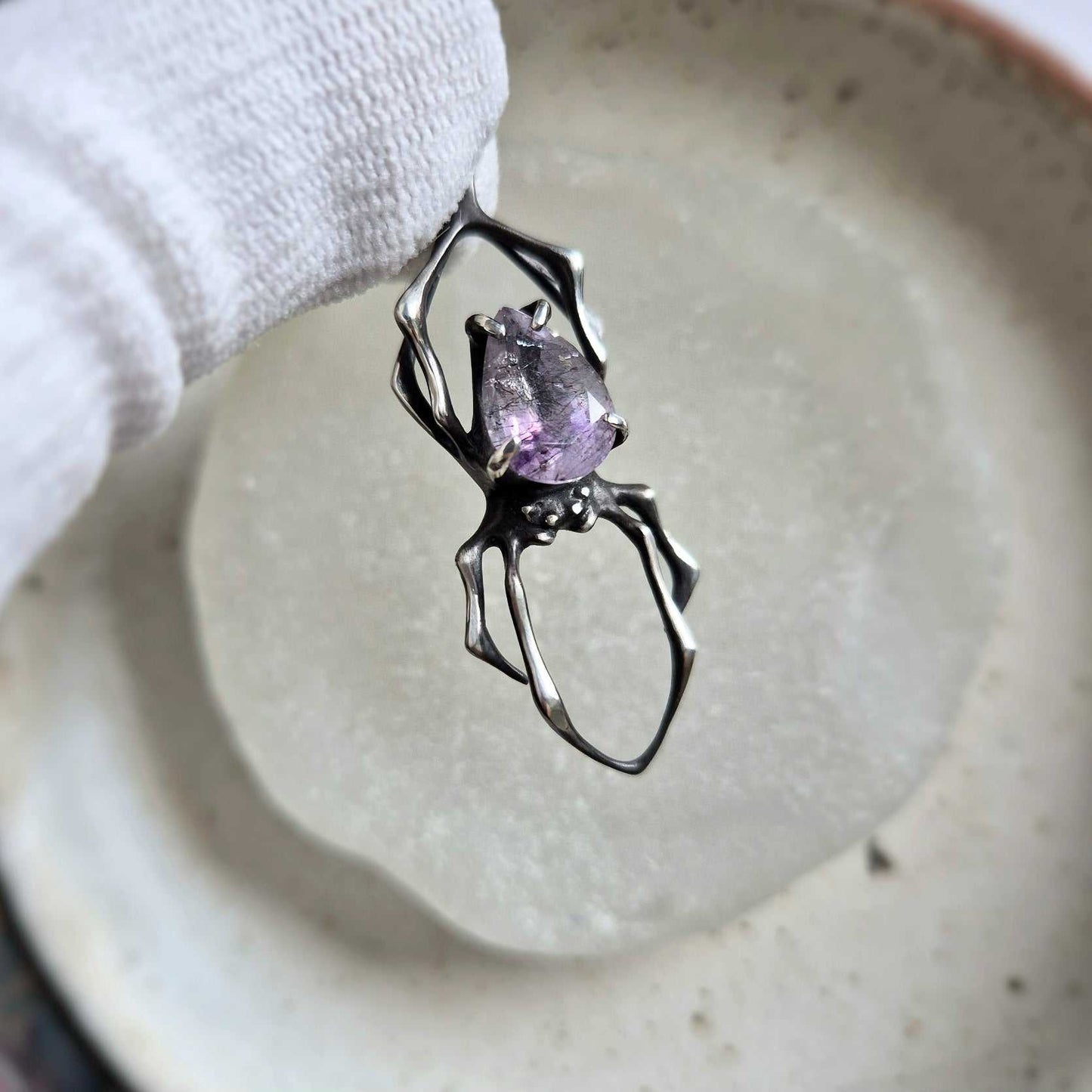 Front view of the silver Spider necklace with Super Seven gemstone, displaying the handcrafted silverwork and natural mineral inclusions.