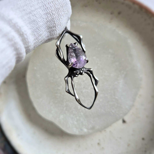 Front view of the silver Spider necklace with Super Seven gemstone, displaying the handcrafted silverwork and natural mineral inclusions.