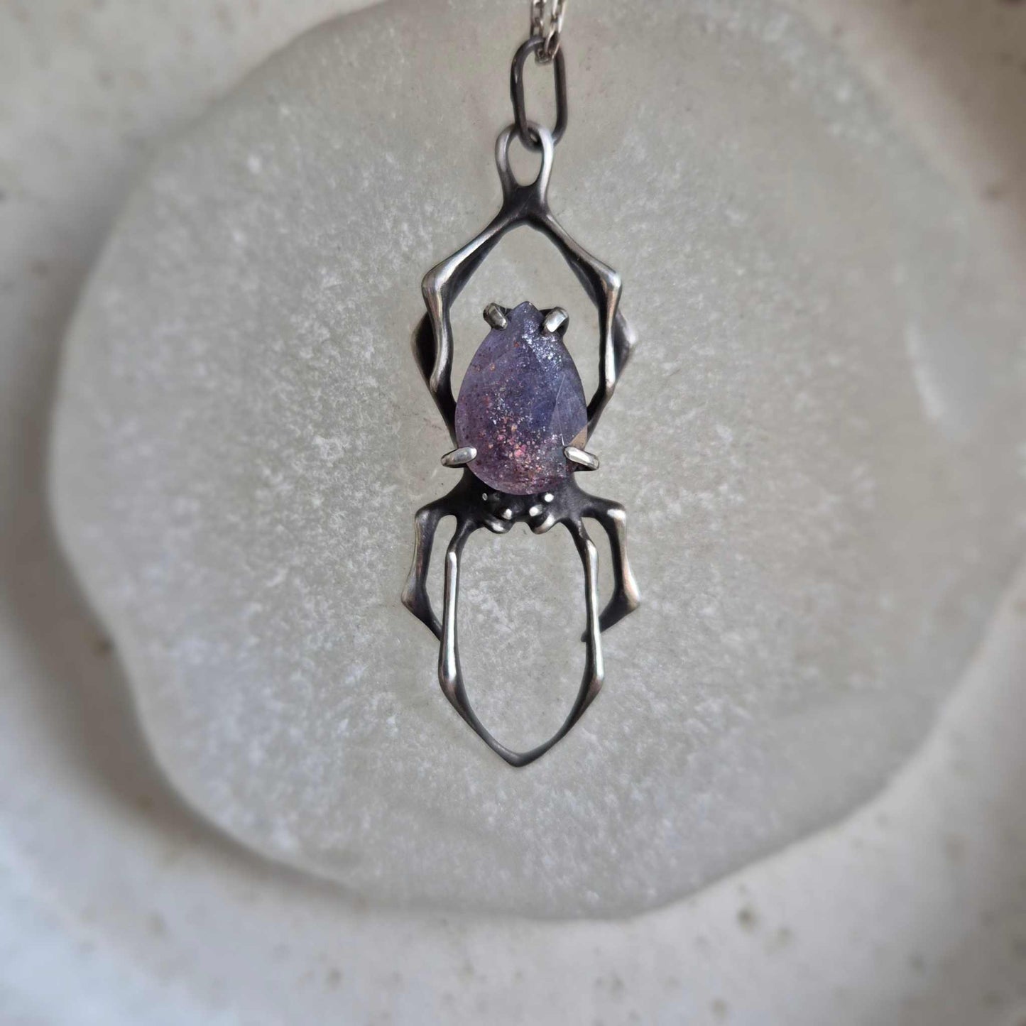Oxidized silver Spider necklace with shimmering iolite sunstone in center