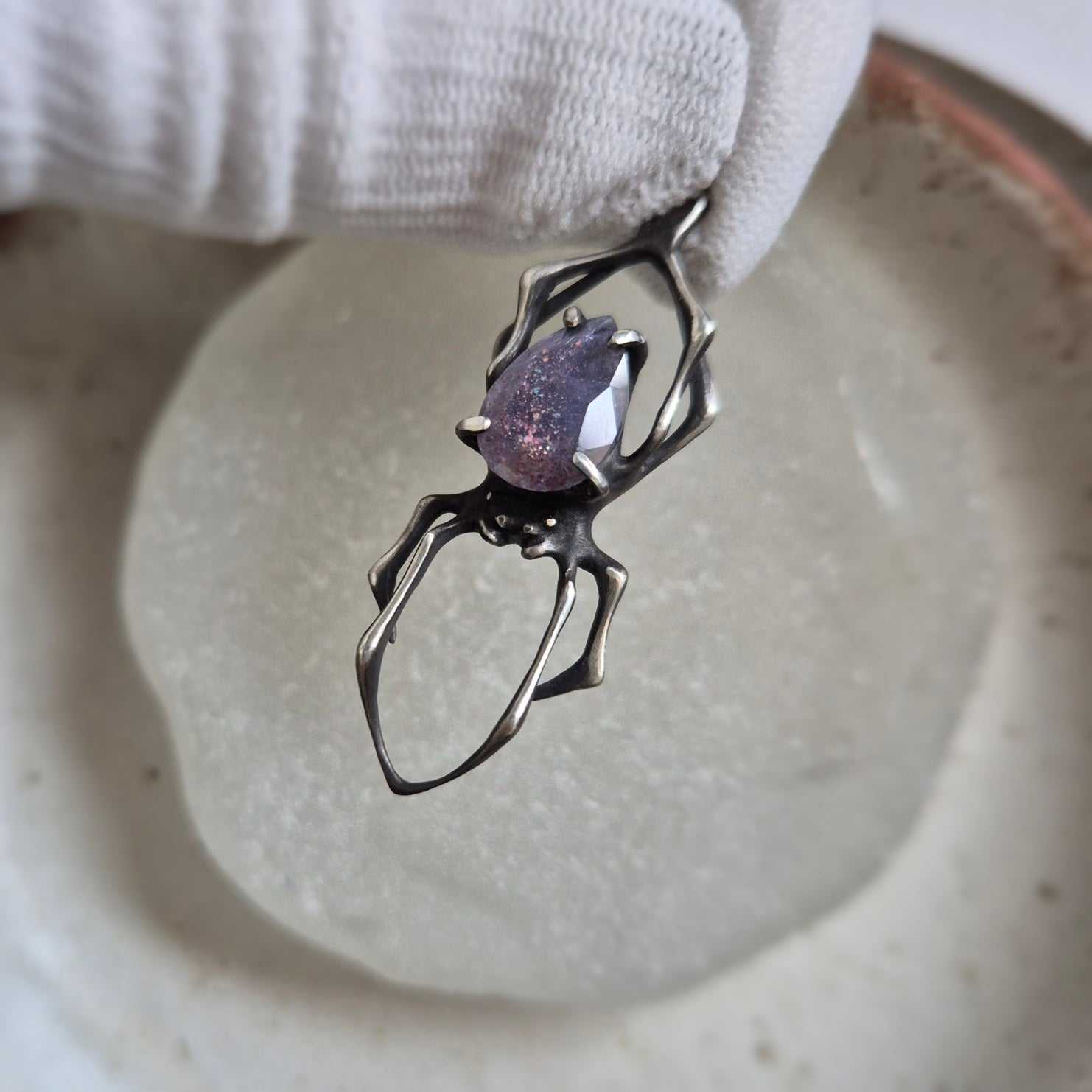Sculptural Spider pendant with blue-violet iolite sunstone, shown from above