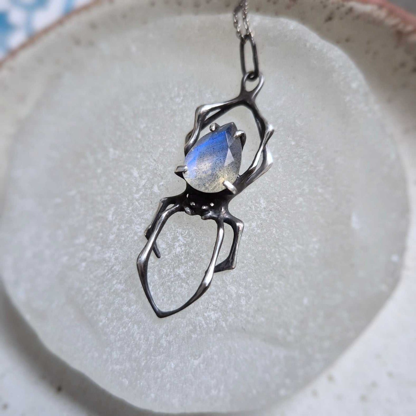 Symbolic spider jewelry piece, handmade with natural textures and detail