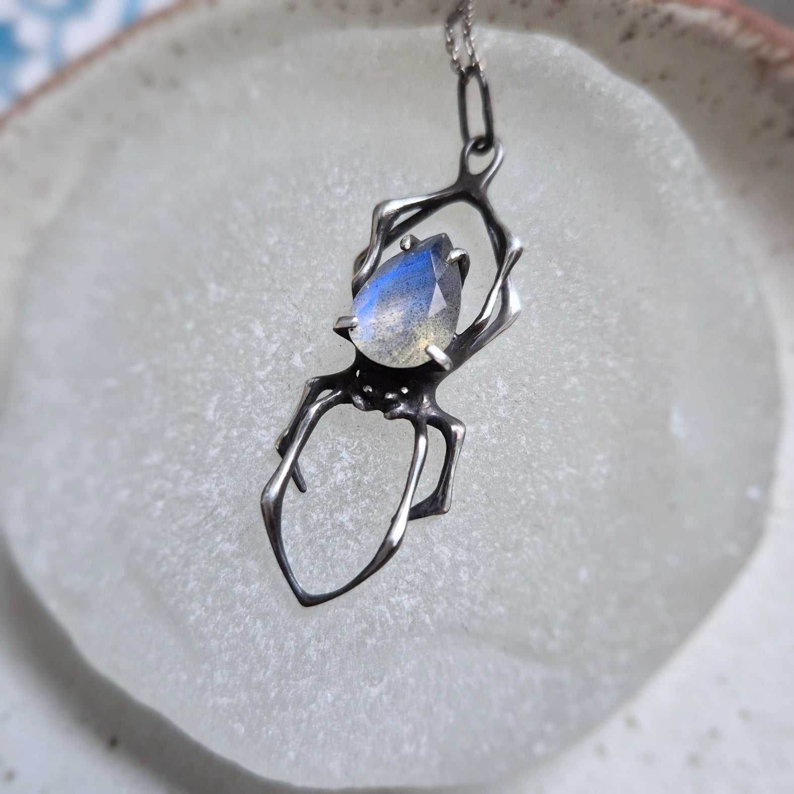 Symbolic spider jewelry piece, handmade with natural textures and detail