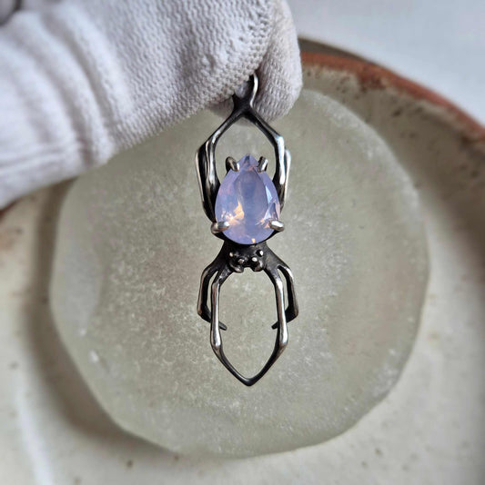 Close-up of handmade silver spider necklace featuring lavender quartz, elegant organic jewelry
