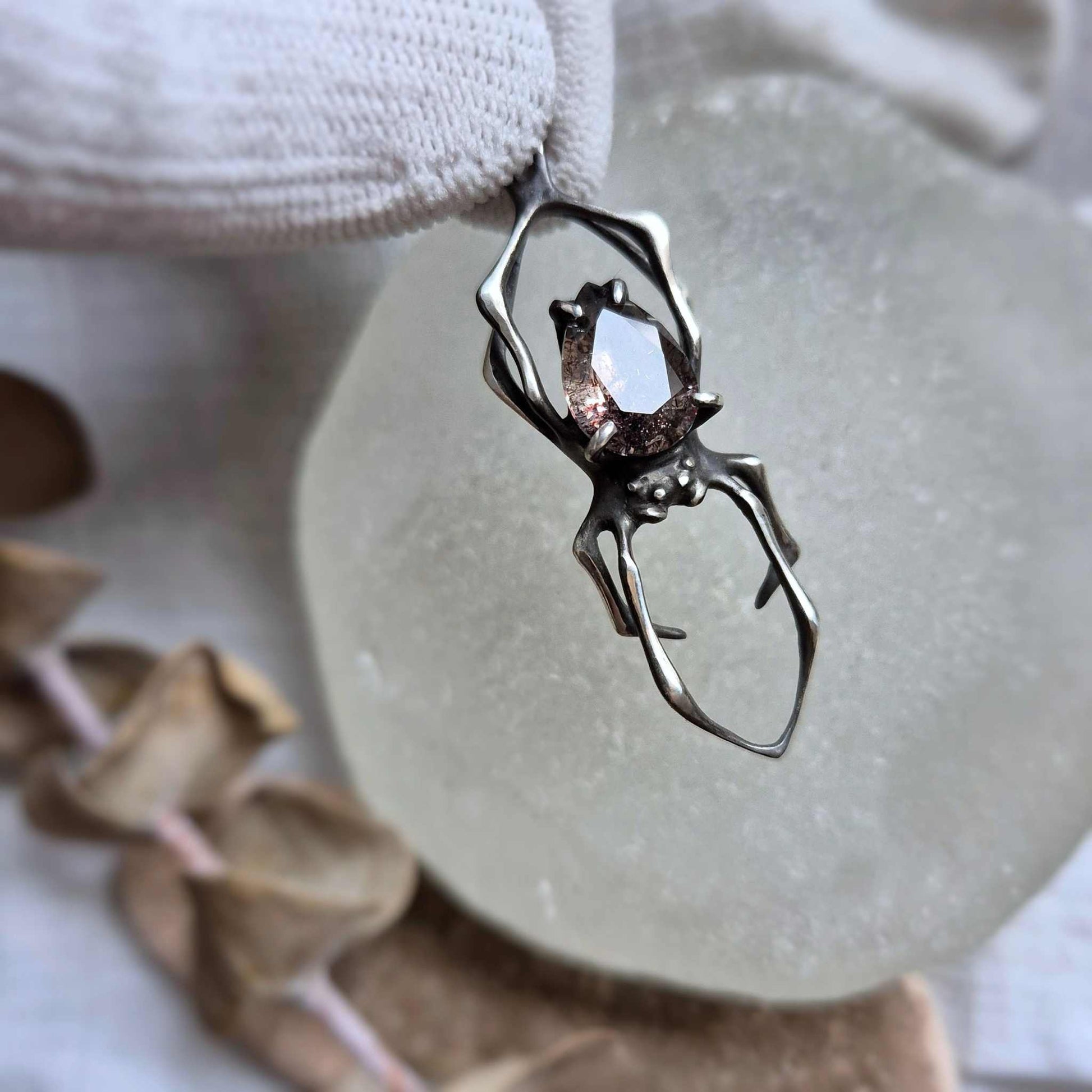 Super Seven silver Spider necklace showing beautiful gem with light flash