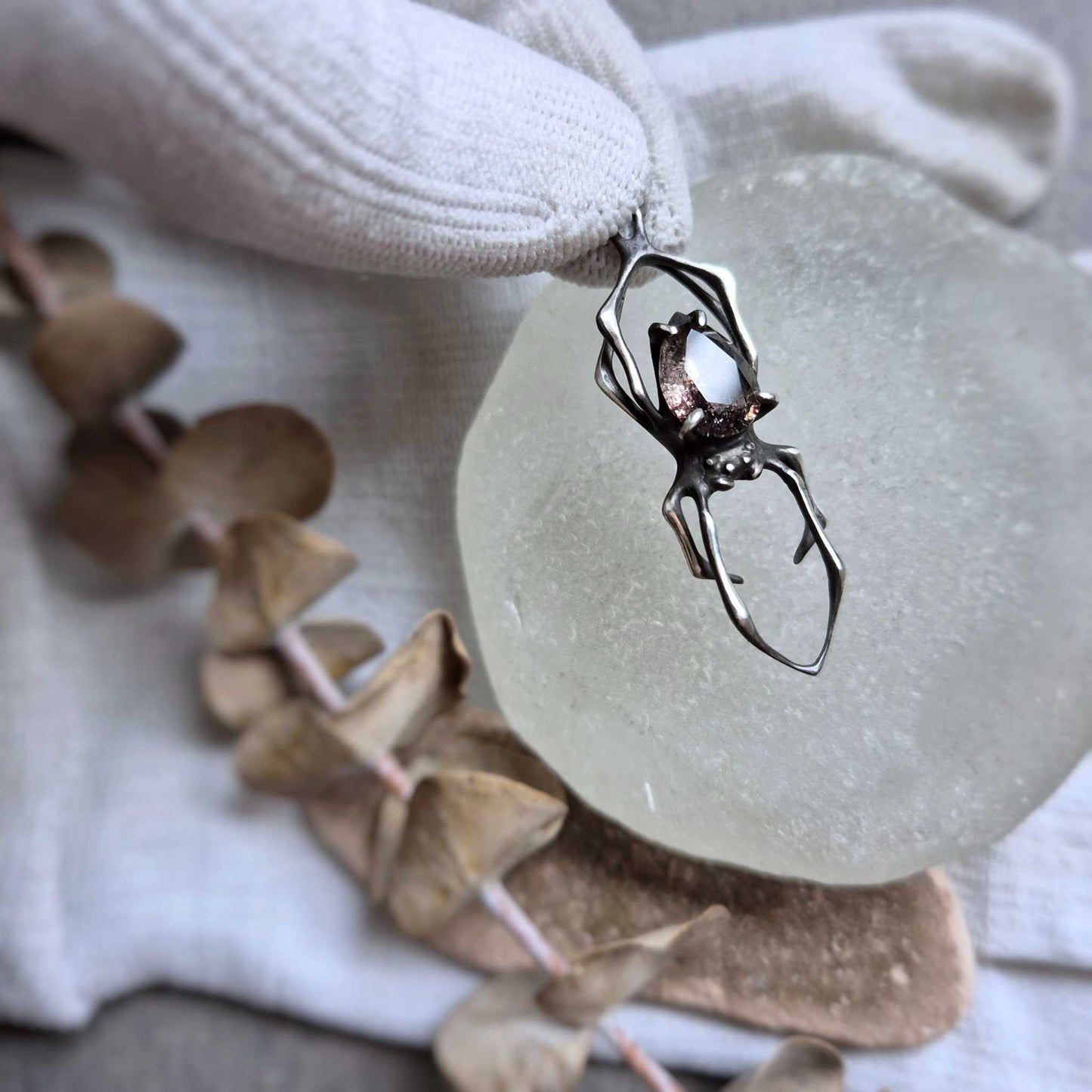 Nature-inspired silver Spider necklace with Super Seven gem, with botanical decor