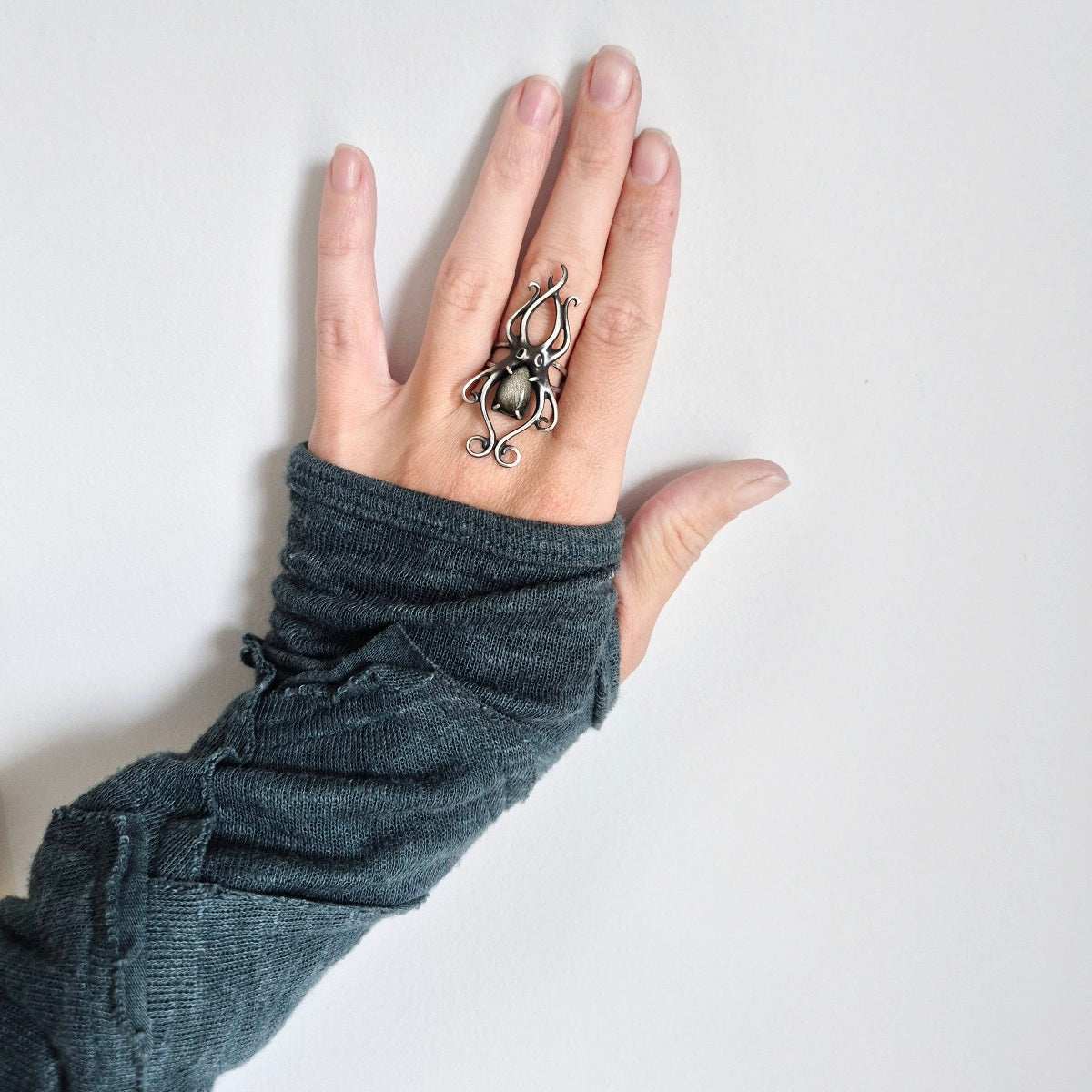 Artisan silver Octopus ring with organic lines, worn on hand in eco fashion sleeve
