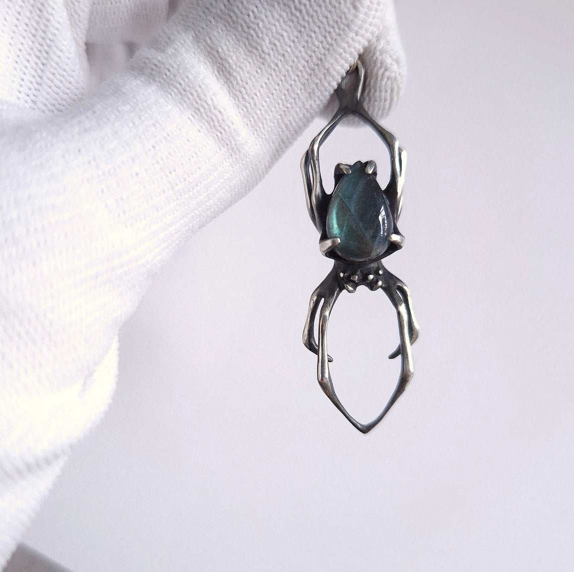 Symbolic spider jewelry piece, handmade with natural textures and detail
