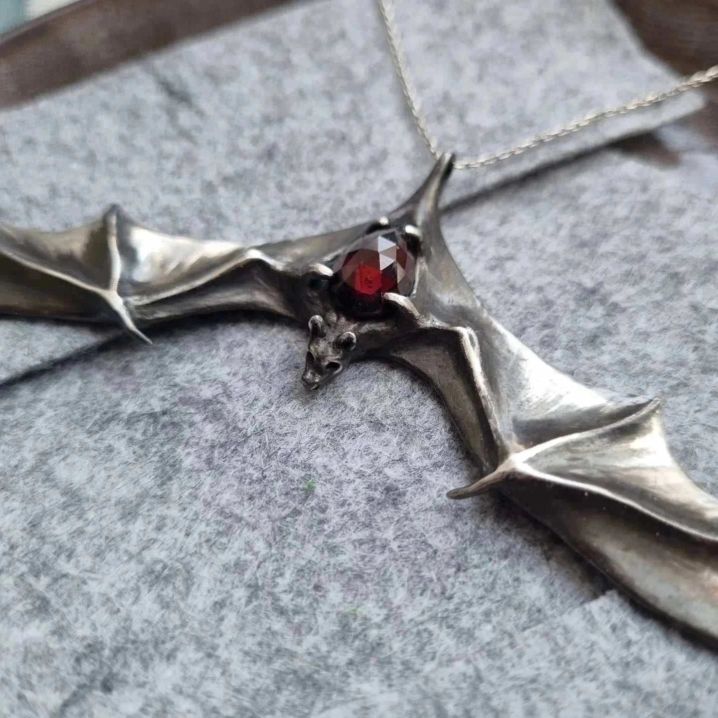 Close0up of Silver Bat necklace - Natural Garnet - Handmade symbolic jewelry