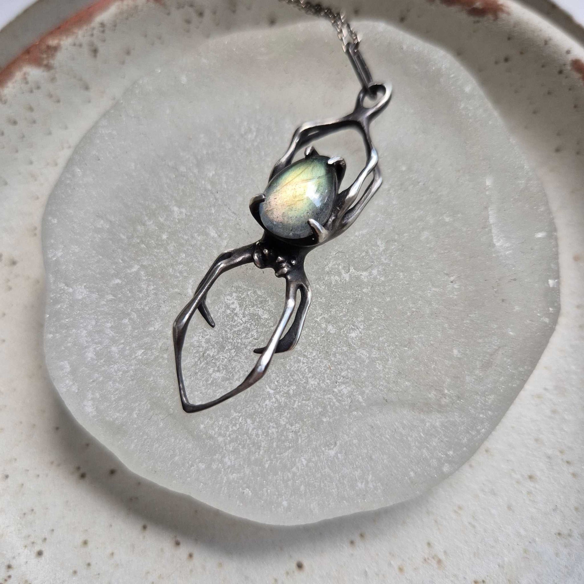 Silver Spider necklace with labradorite, sculptural jewelry captured from above