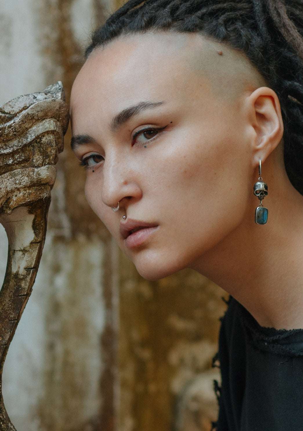A model wearing silver Skull earrings with blue labradorites, ethnic boho style