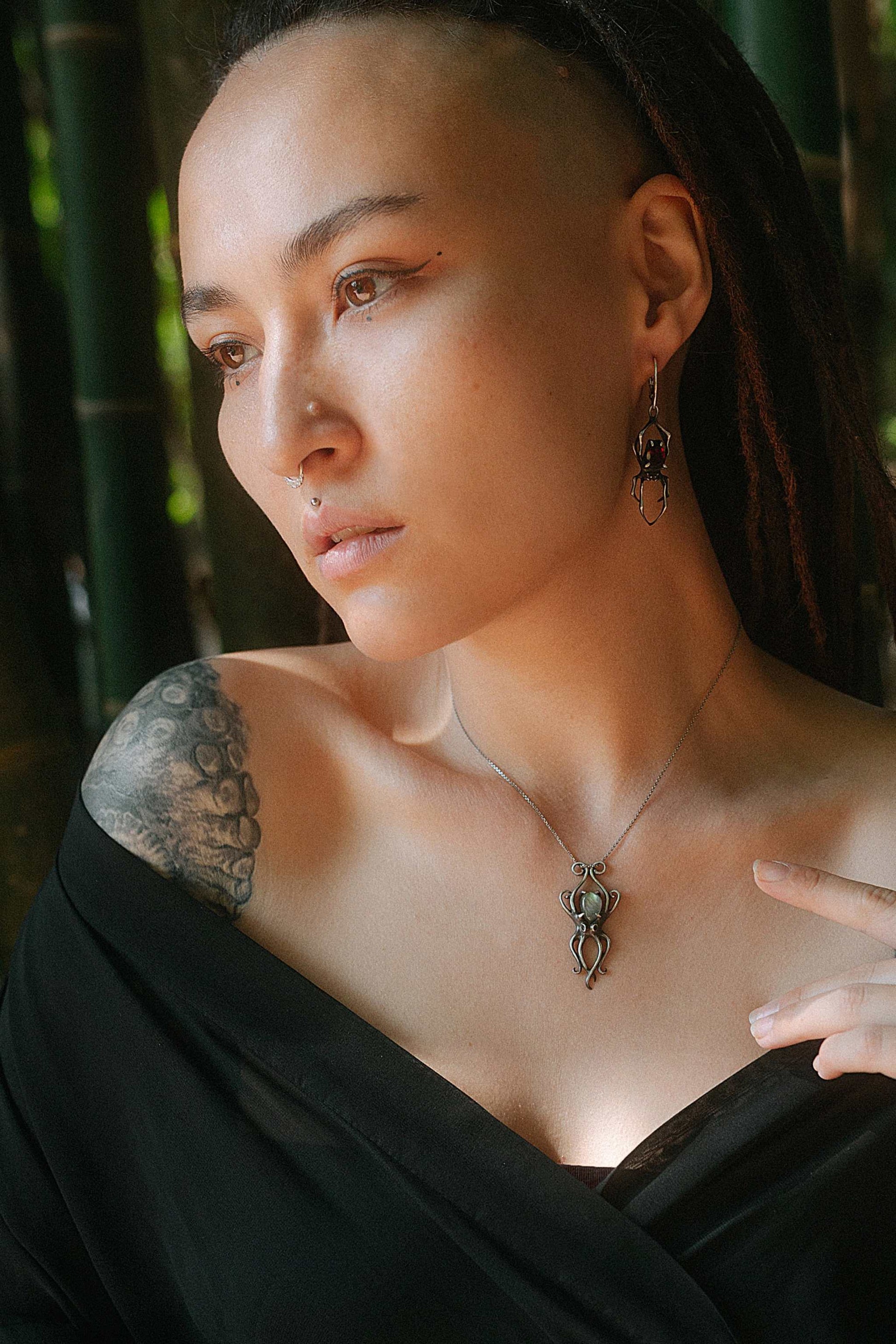 Model wearing silver octopus necklace with labradorite gemstone, styled with matching Spider earrings
