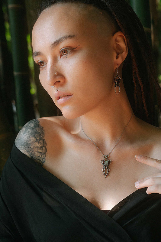 Model wearing silver octopus necklace with labradorite gemstone, styled with matching Spider earrings