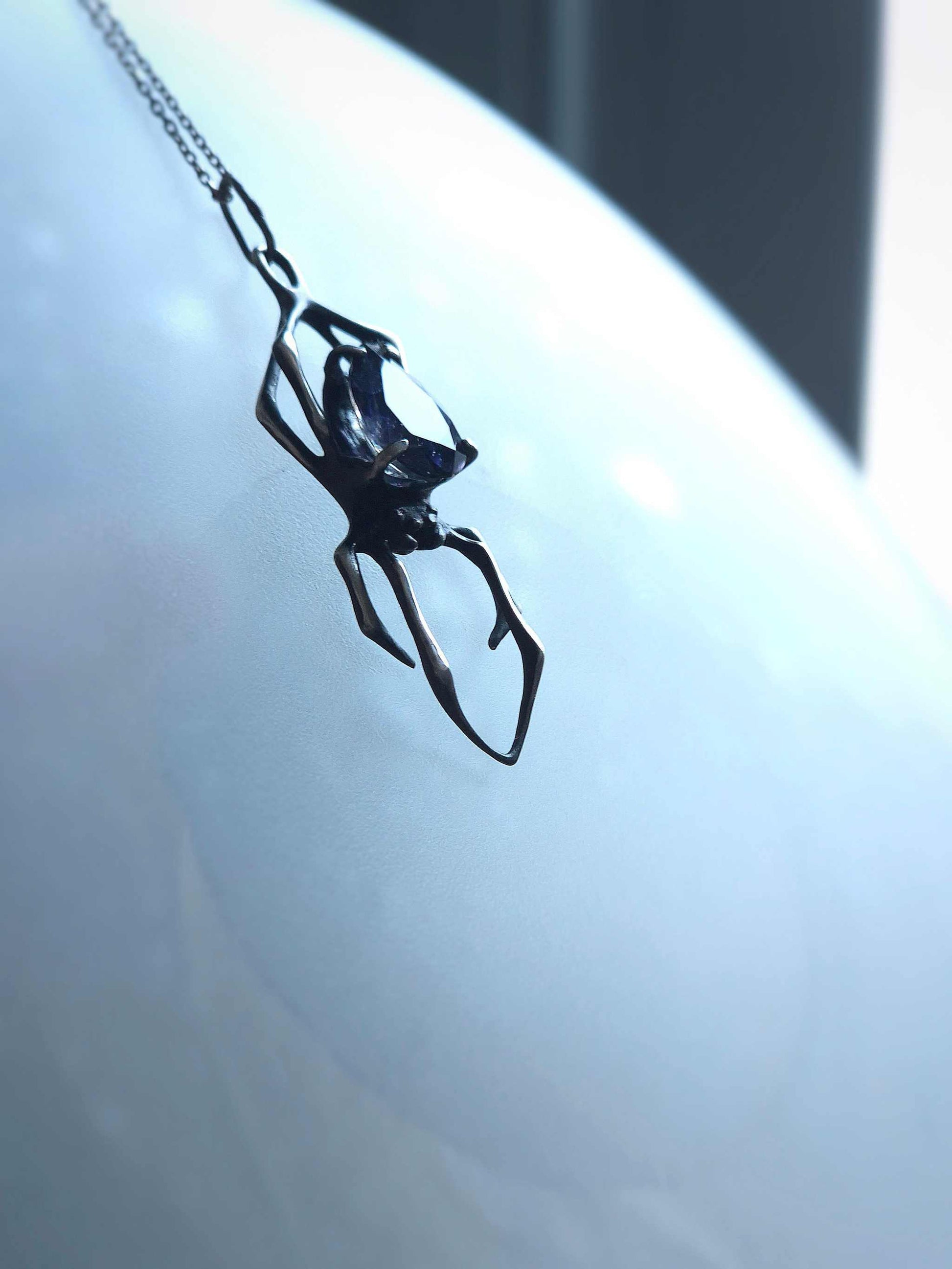 Creation Spider talisman on blurry background