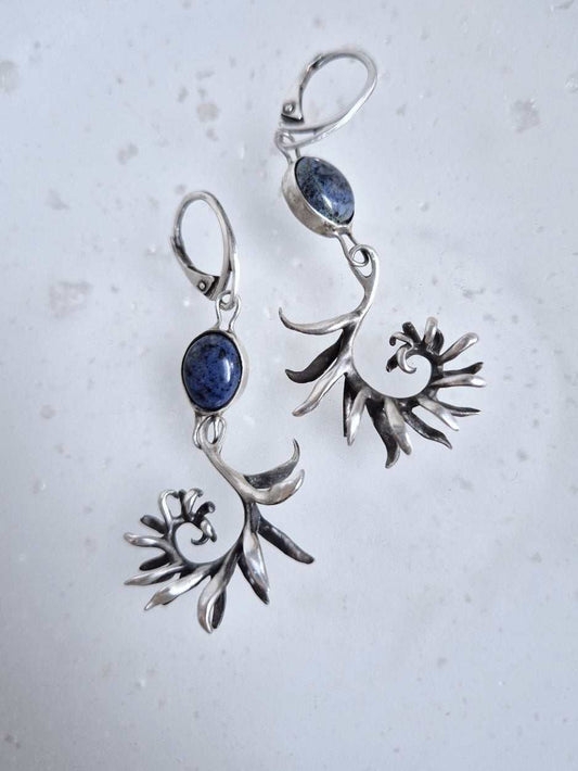 Sterling-silver fern earrings with gray-blue dumortierite cabochons on light backdrop