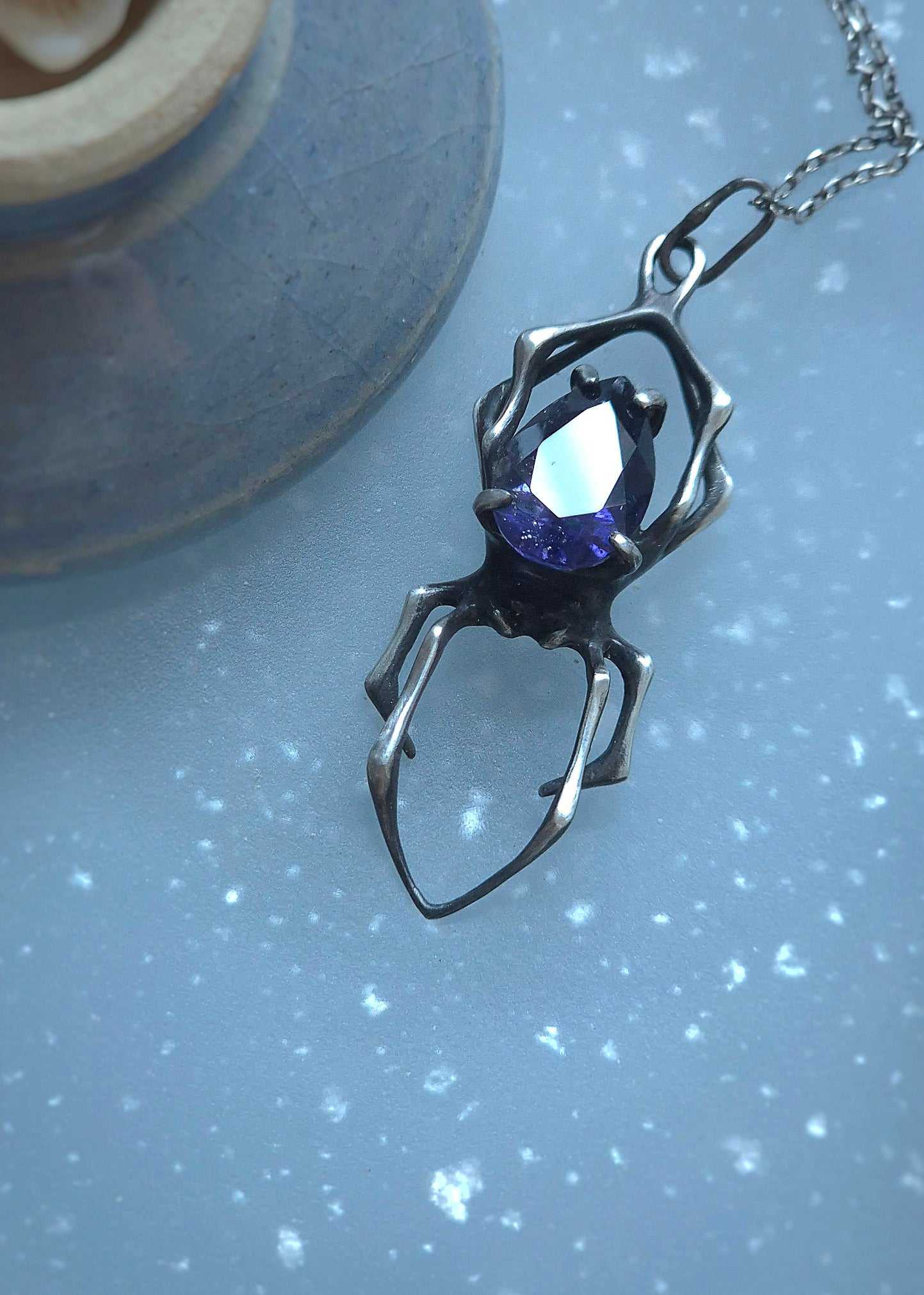 Symbolic spider jewelry piece, handmade with natural textures and detail