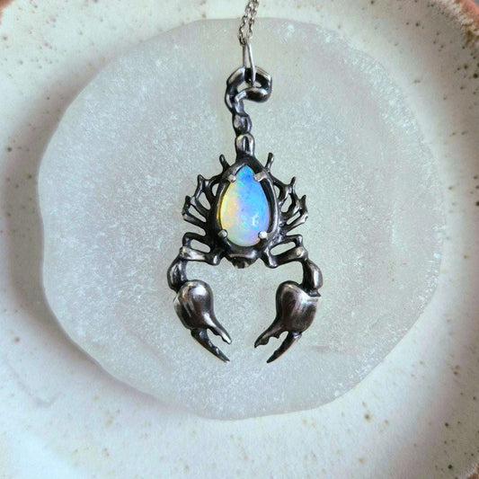 Front view of the silver Scorpion necklace with a teardrop opal, showcasing the stone’s play of light