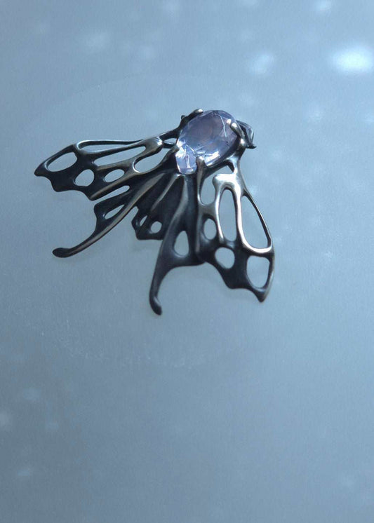 Oxidized silver Moth pendant with pale violet quartz gemstone in gentle lighting