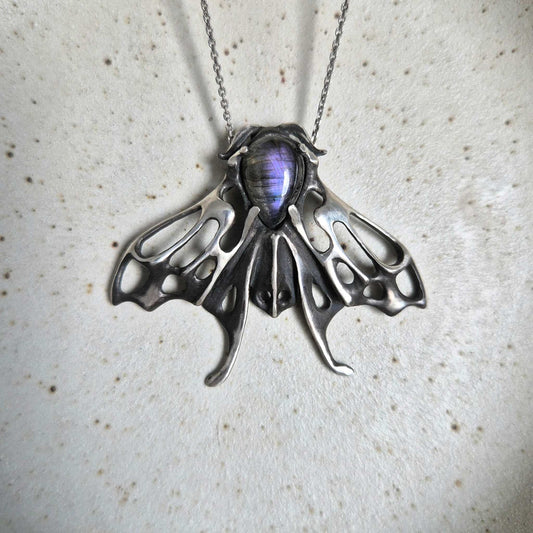 Handcrafted silver Moth necklace featuring a purple labradorite