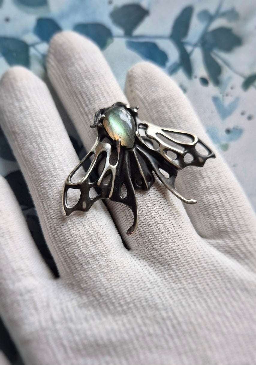 Close-up of silver Moth ring featuring pale labradorite stone, bold mystical jewelry piece