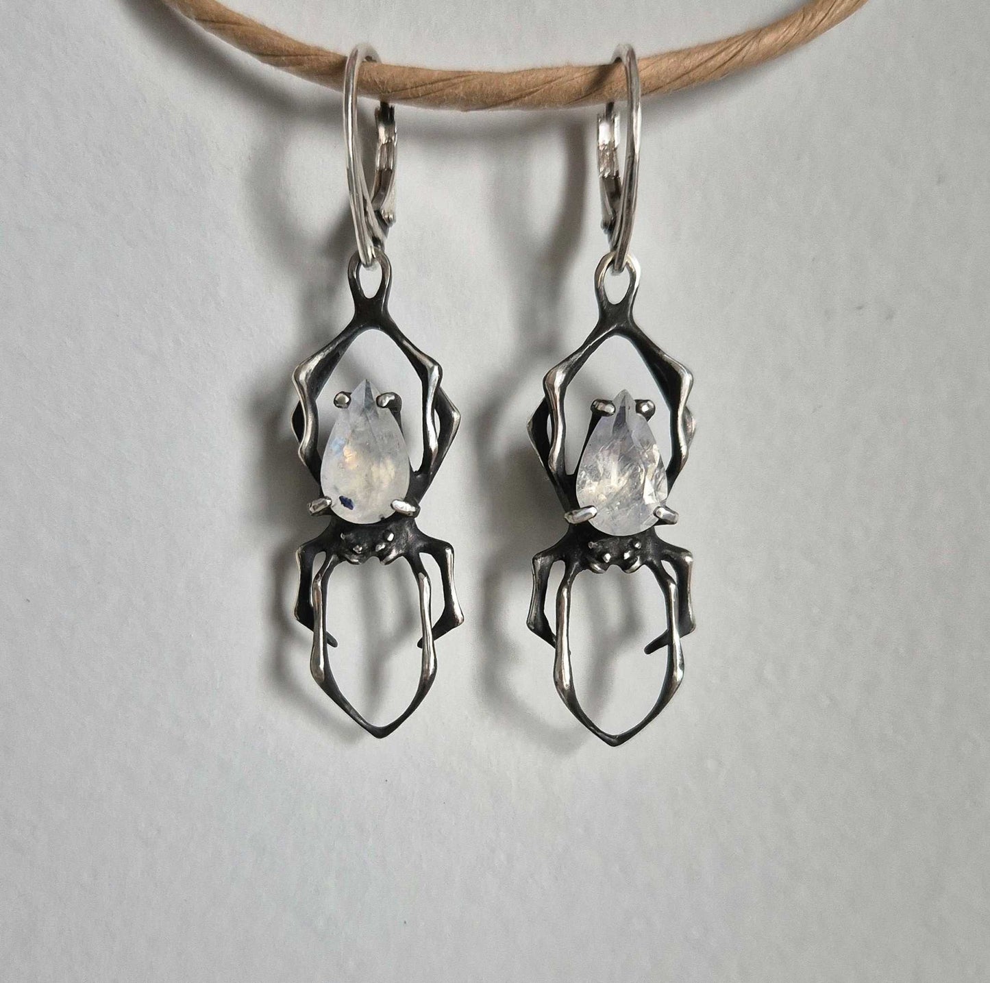Faceted rainbow moonstone Spider earrings shown from top angle
