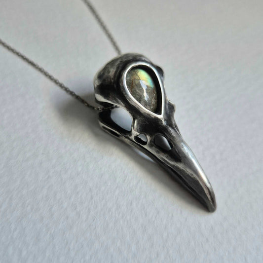 Raven skull necklace in oxidized silver with labradorite gemstone, angled top view