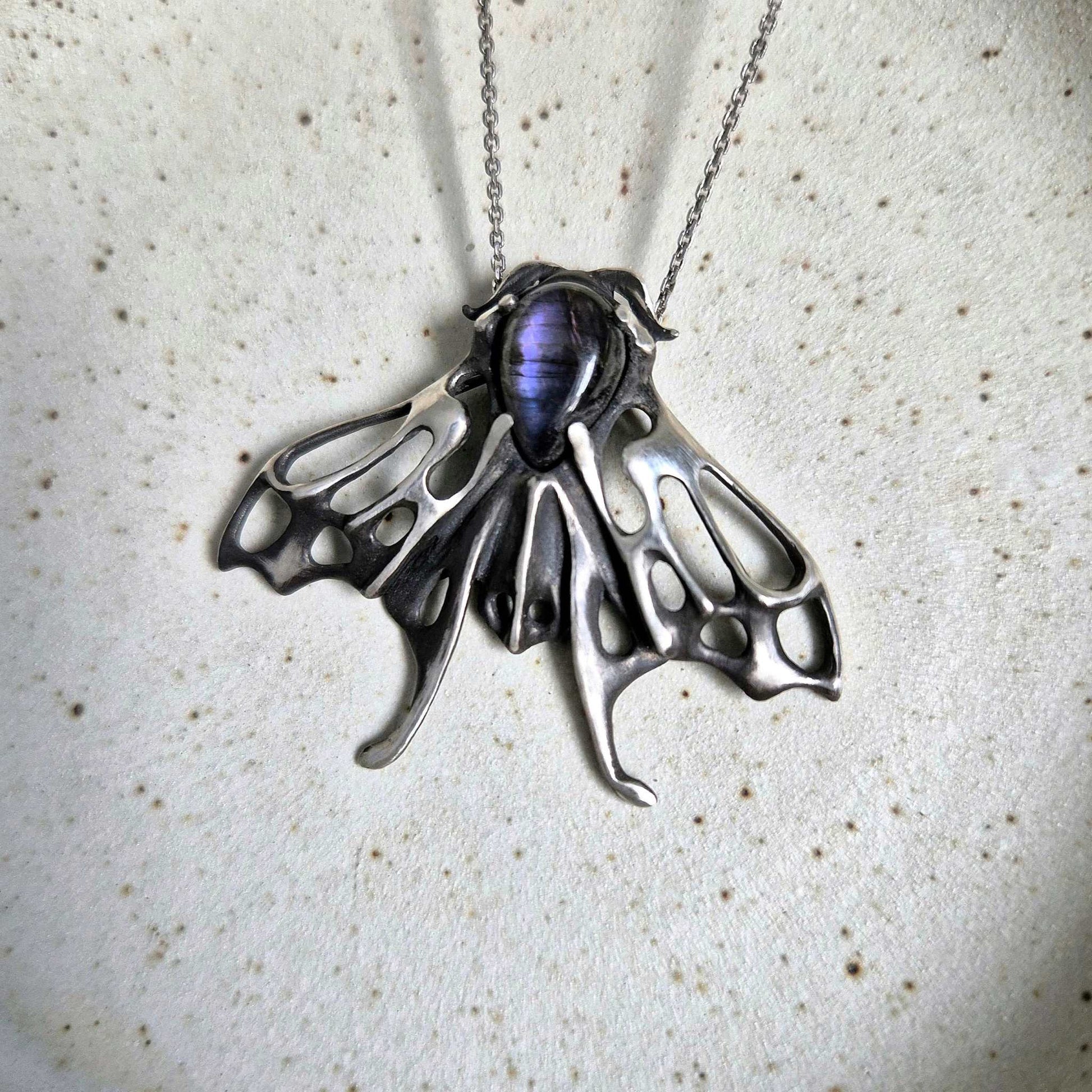 Delicate Moth necklace with shimmering purple labradorite