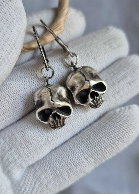 Gothic-style silver Skull earrings with an organic, slightly imperfect texture that feels alive.