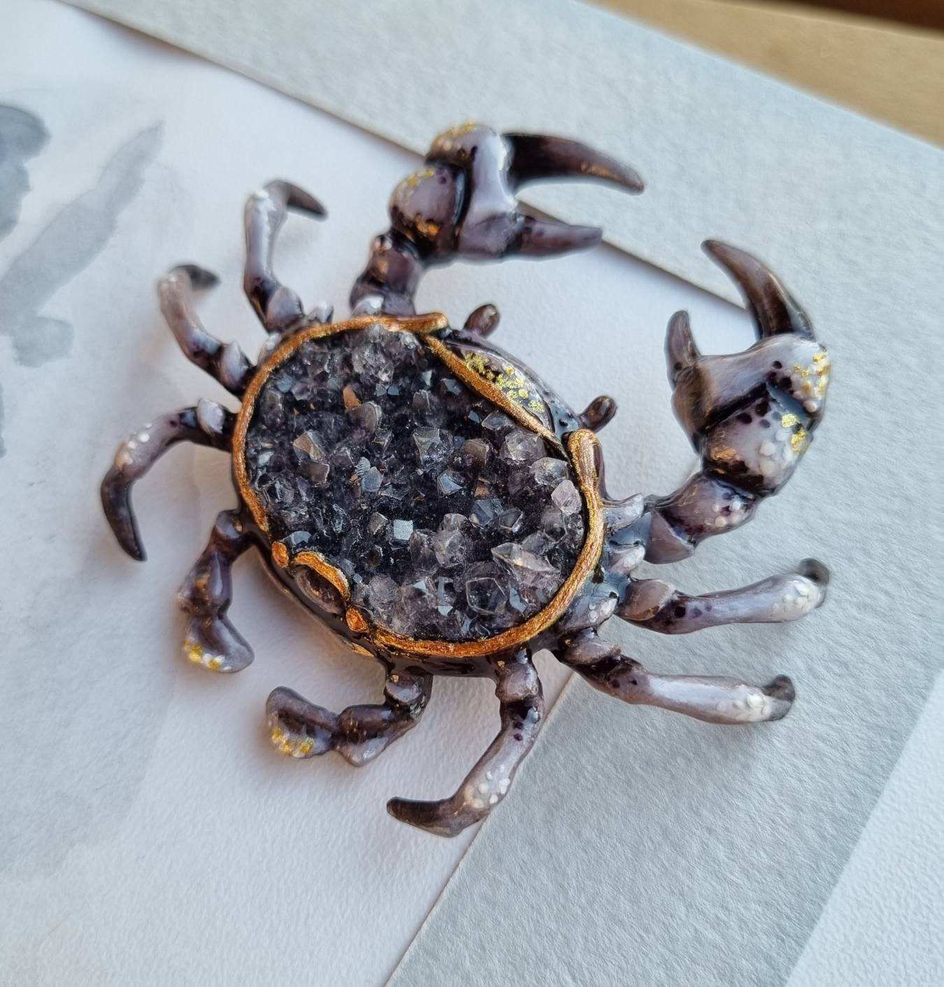 Handmade resin crab with smoky quartz cluster, photographed in daylight.