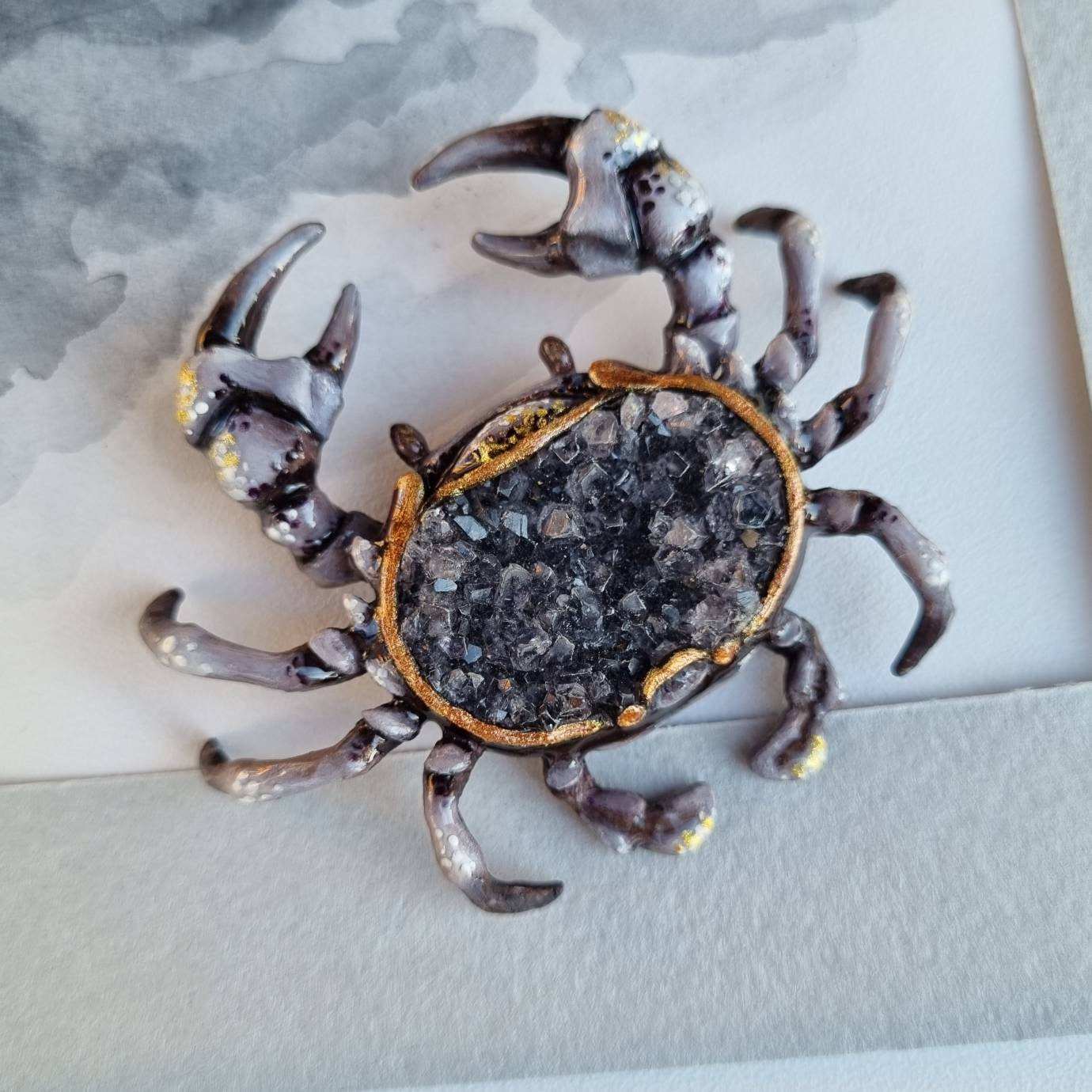 Artistic figurine of crab with smoky quartz, styled with soft shadows.
