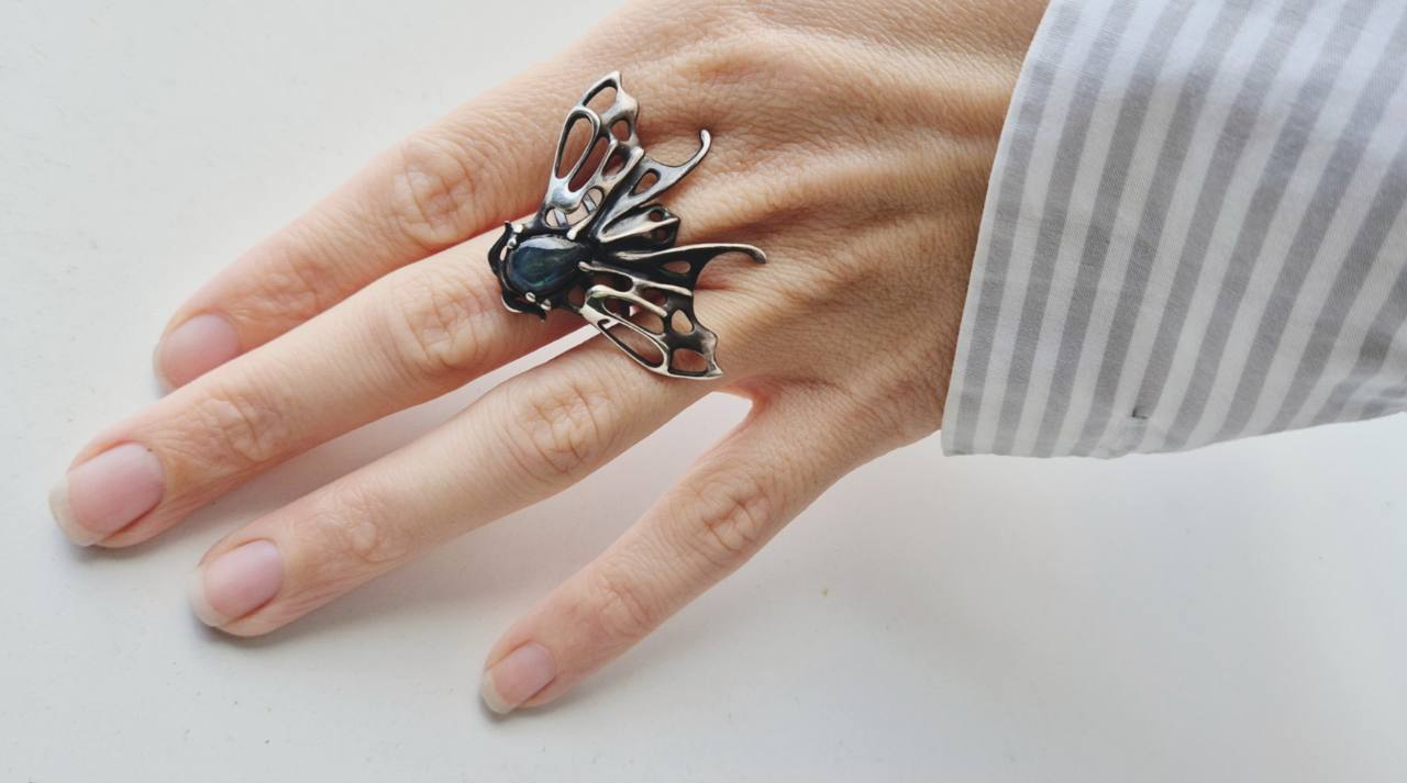 Moth ring in sterling silver worn on a hand