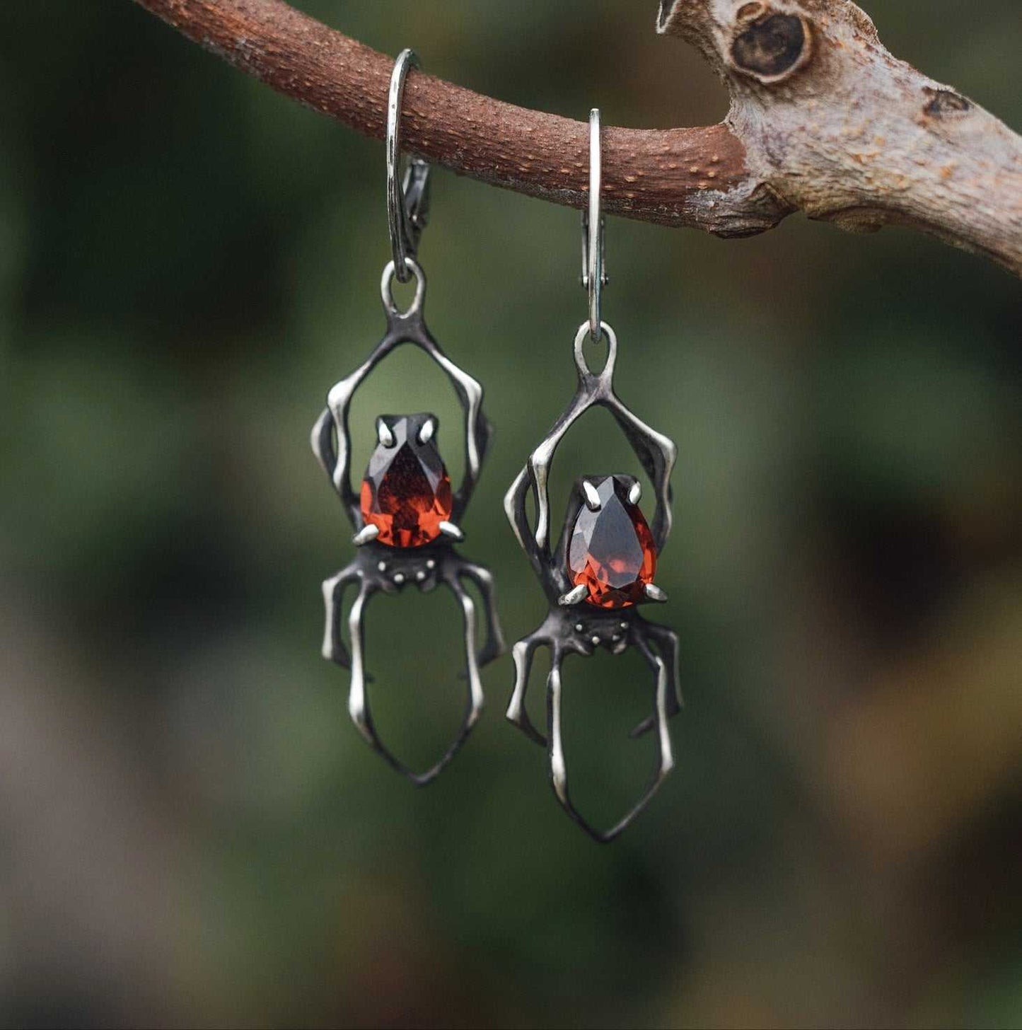 Dragonblood Spider earrings with faceted garnets, handmade Witchy silver jewelry