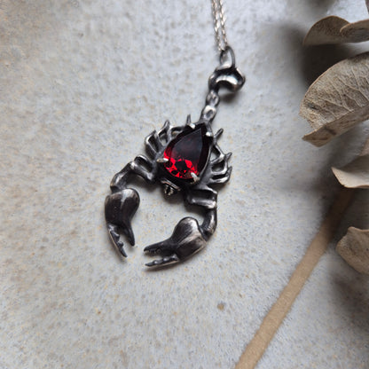 Dragonblood Scorpion pendant with a faceted garnet, handmade witchy talisman