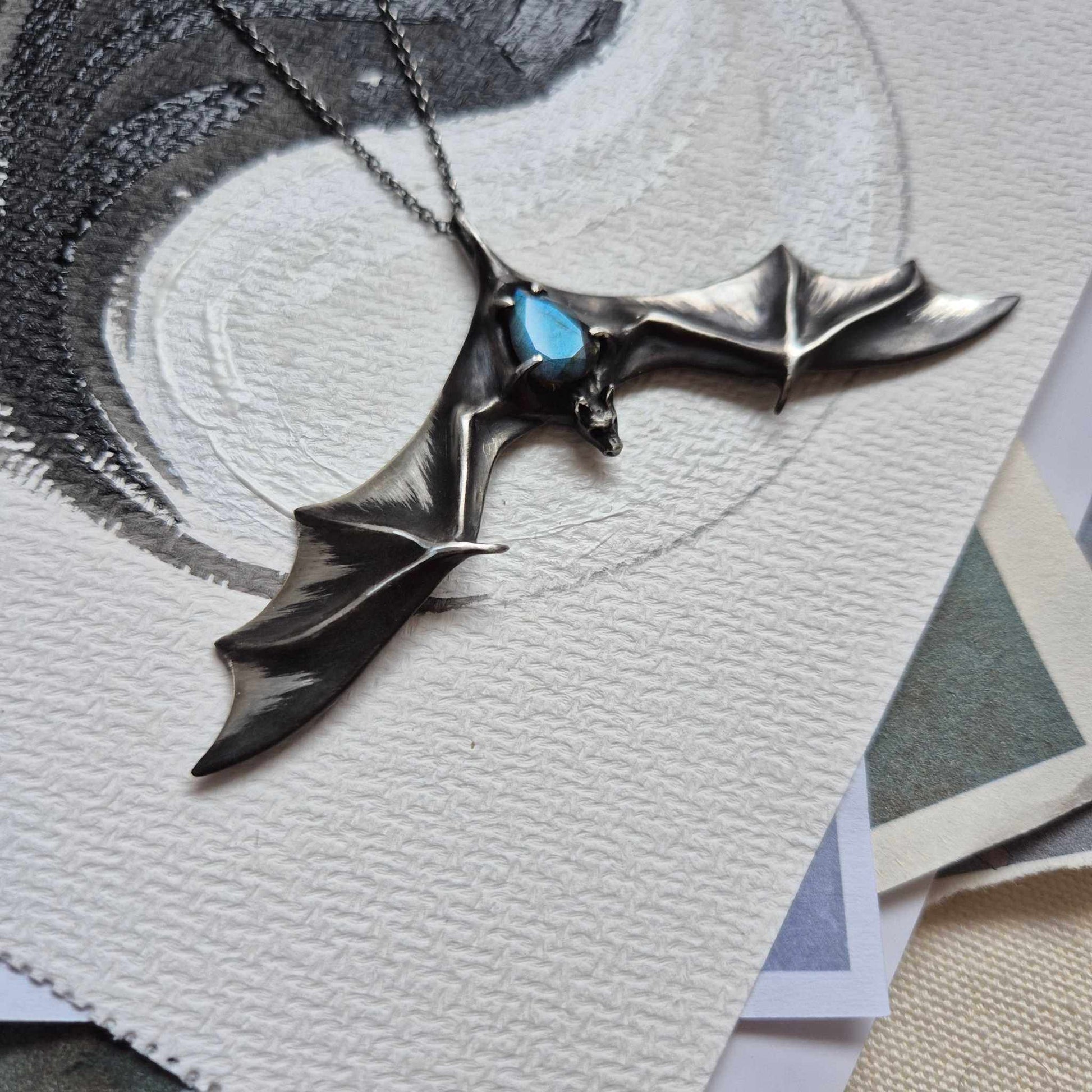 Aurora Bat pendant with a faceted blue labradorite gem, handmade Witchy - Vampire cosplay talisman front left view