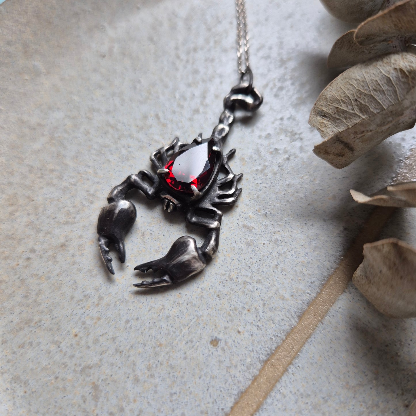 Dragonblood Scorpion pendant with a faceted garnet, handmade witchy talisman