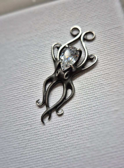 Close-up of the silver octopus necklace with clear zircon, photographed against a neutral background.