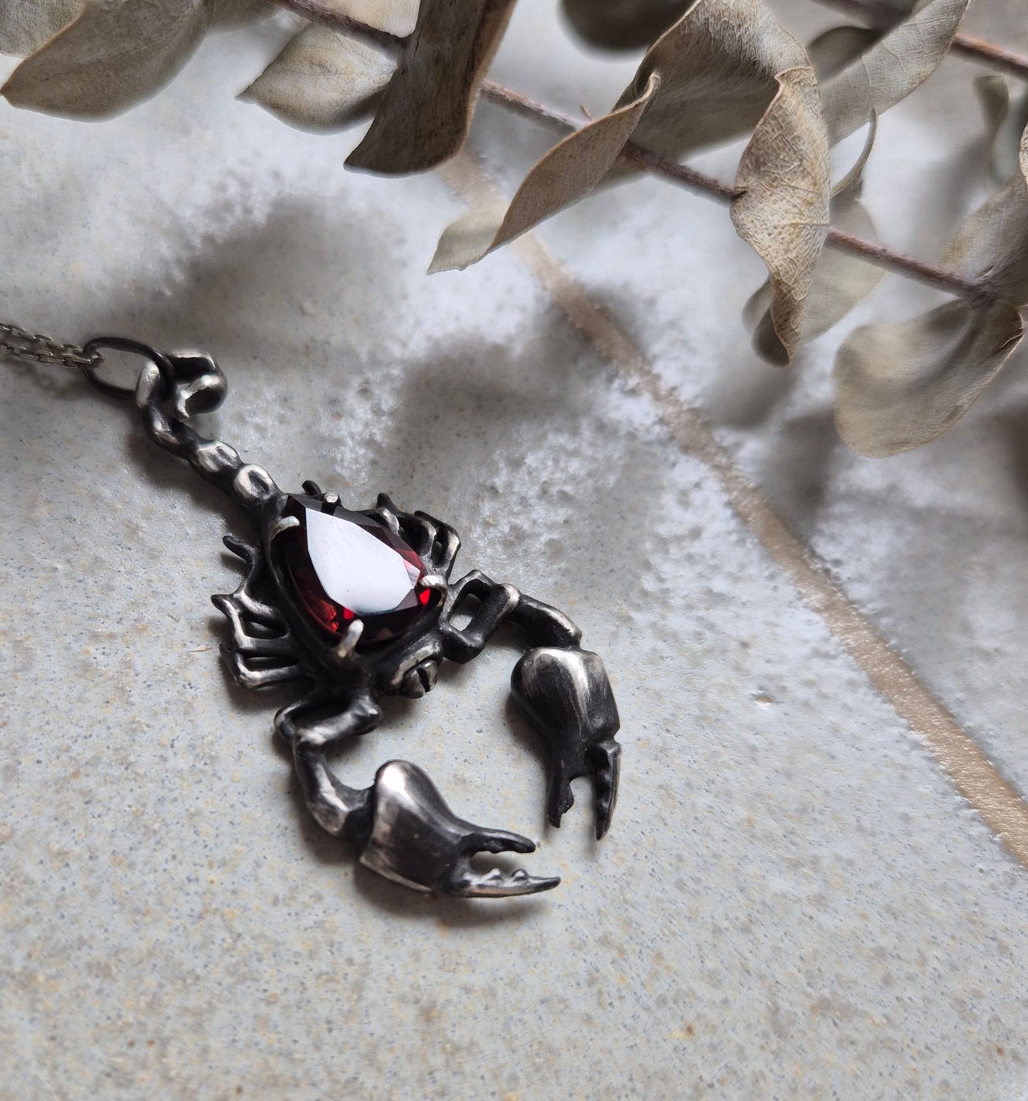 Dragonblood Scorpion pendant with a faceted garnet, handmade witchy talisman