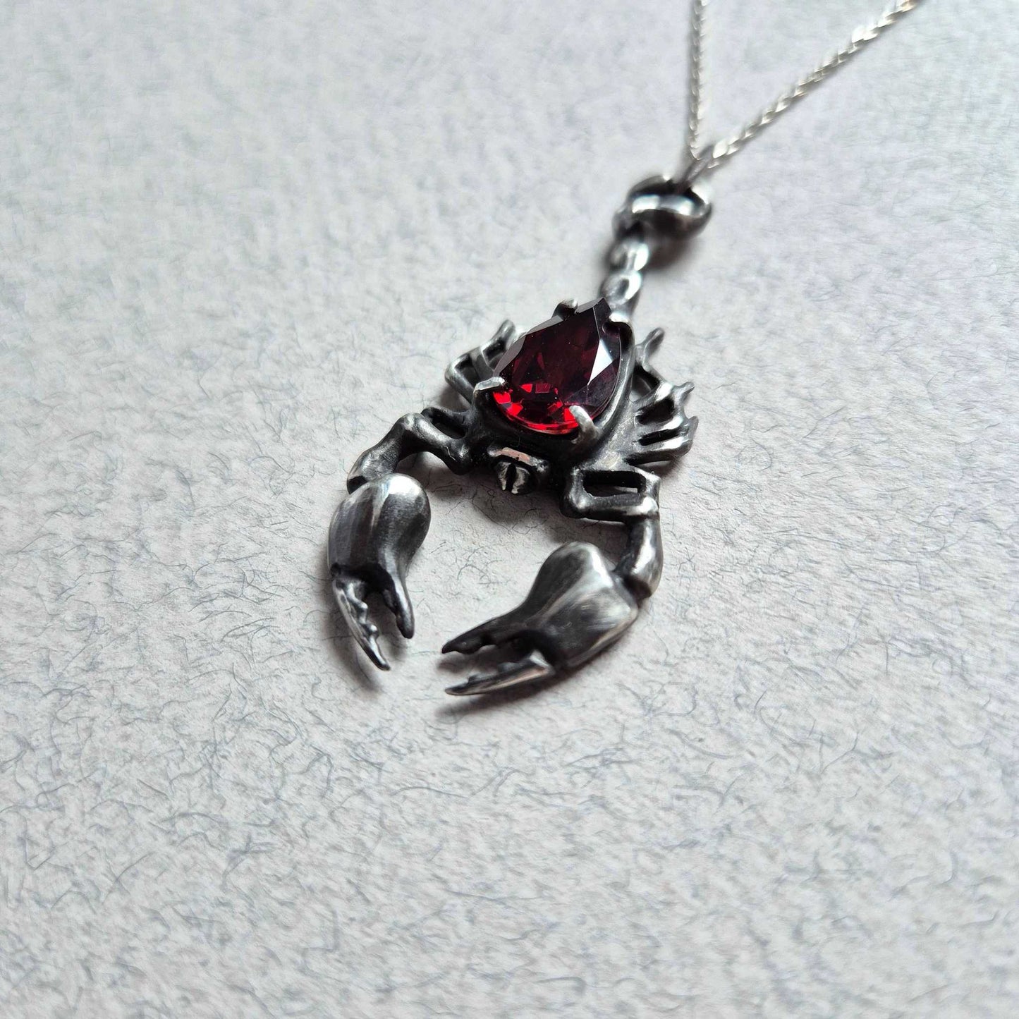 Dragonblood Scorpion pendant with a faceted garnet, handmade witchy talisman