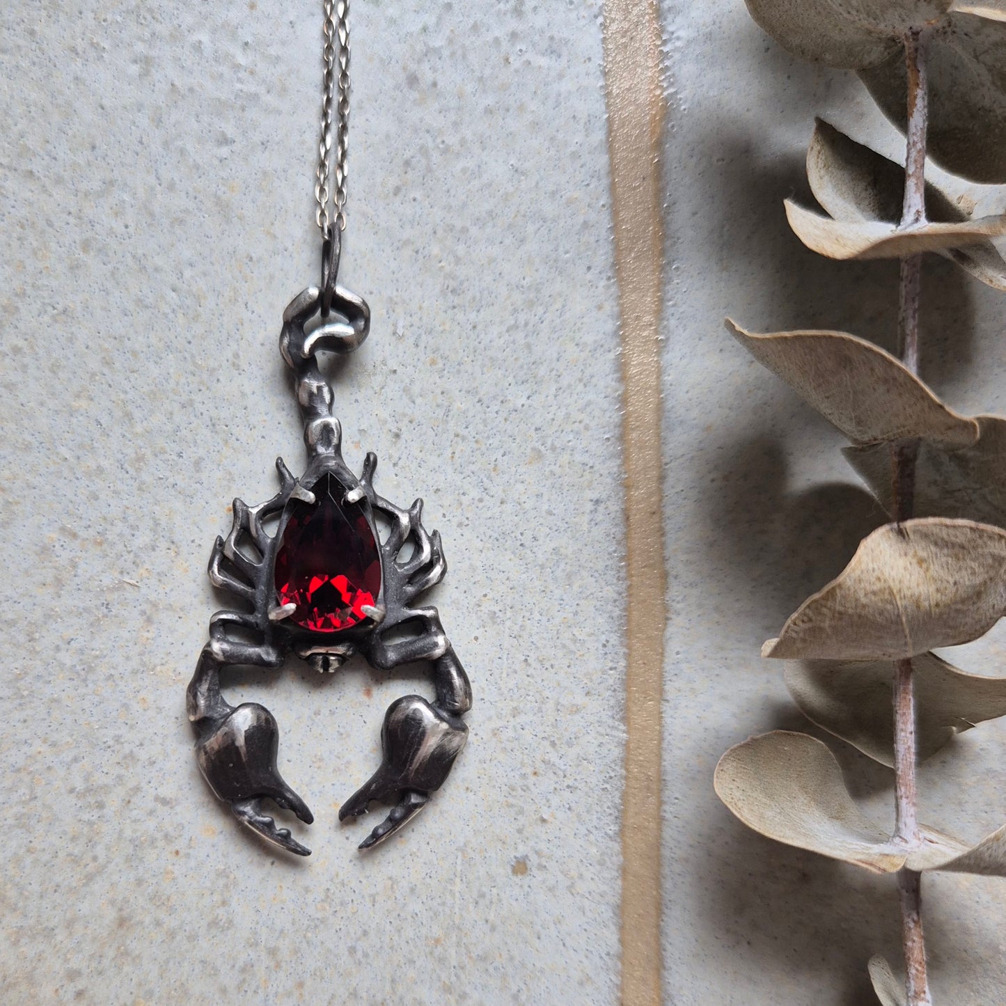 Dragonblood Scorpion pendant with a faceted garnet, handmade witchy talisman