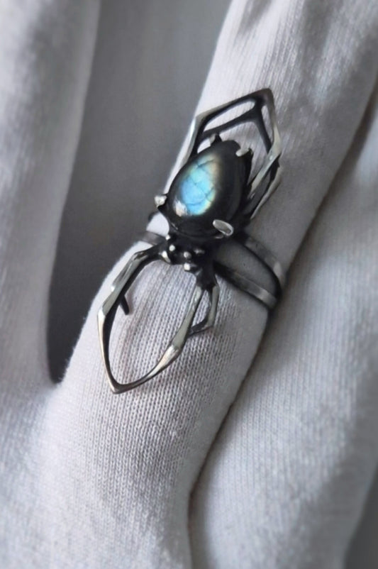 Oxidized sterling silver spider ring with vivid blue-flash labradorite on a white glove