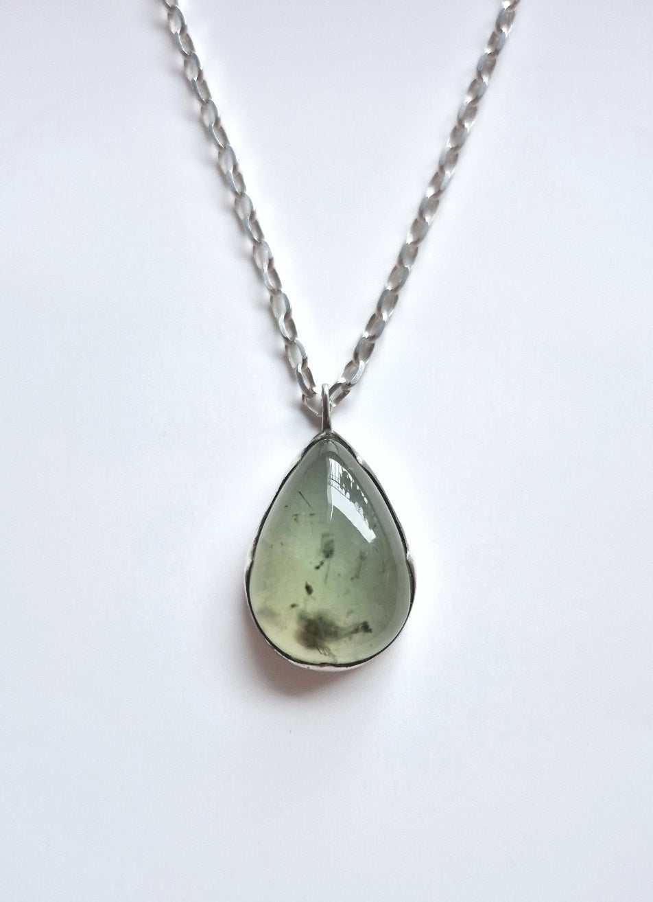 rehnite necklace in sterling silver on a simple background