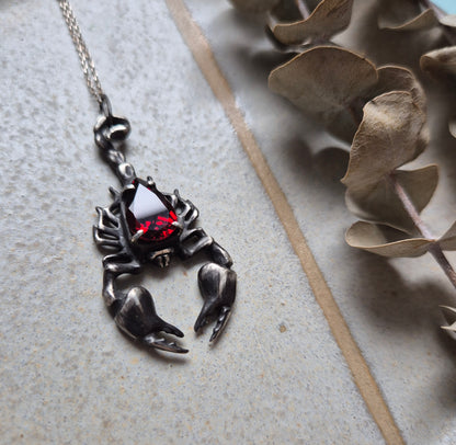 Dragonblood Scorpion pendant with a faceted garnet, handmade witchy talisman