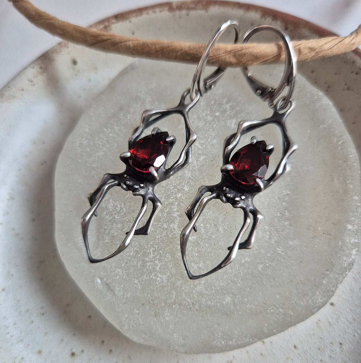 Dragonblood Spider earrings with faceted garnets, handmade Witchy silver jewelry