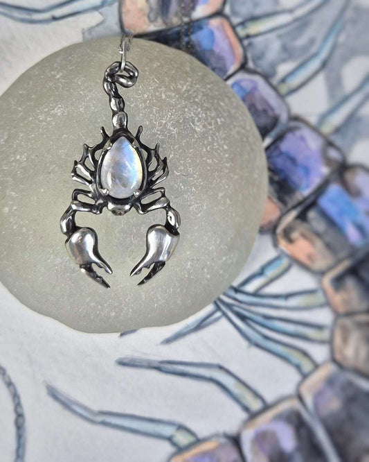 Scorpion necklace in Sterling Silver with Rainbow Moonstone on blue and purple watercolor background