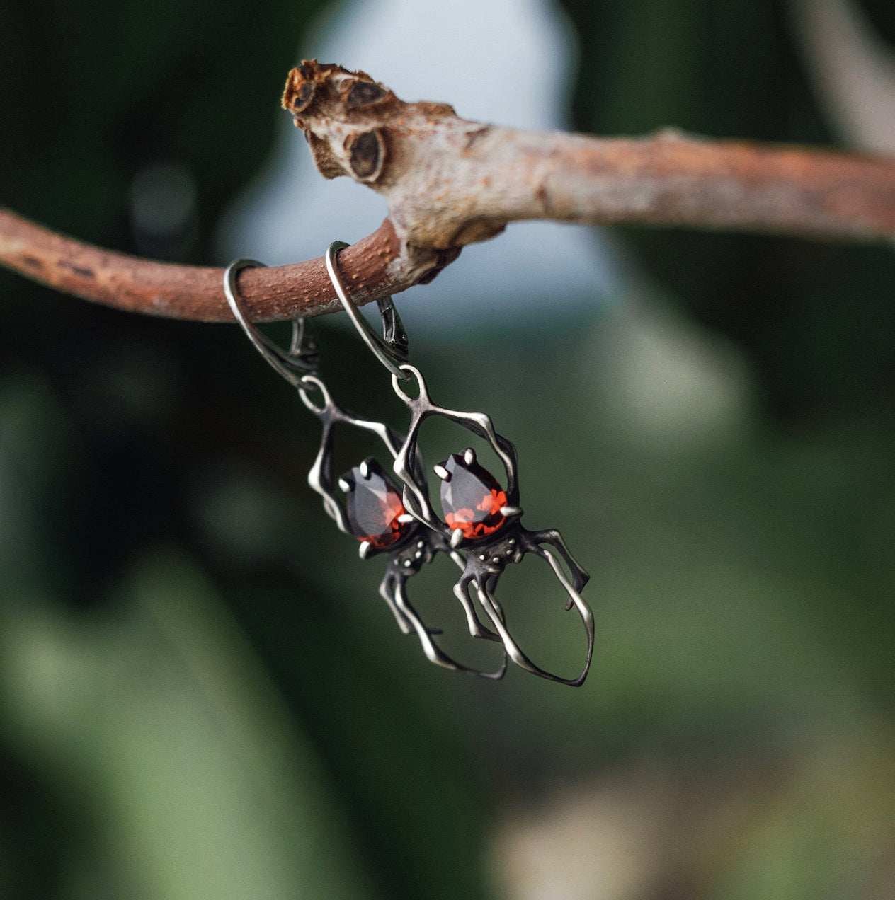 Dragonblood Spider earrings with faceted garnets, handmade Witchy silver jewelry