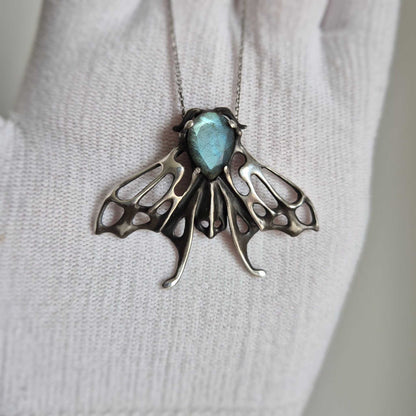 Blue Aurora Moth pendant with a faceted light blue labradorite gem, silver talisman