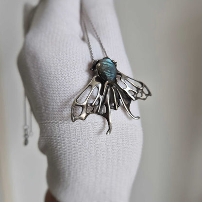 Blue Aurora Moth pendant with a faceted light blue labradorite gem, silver talisman