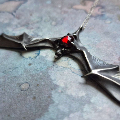 Dragonblood Bat pendant with a garnet gem, handmade Witchy silver talisman