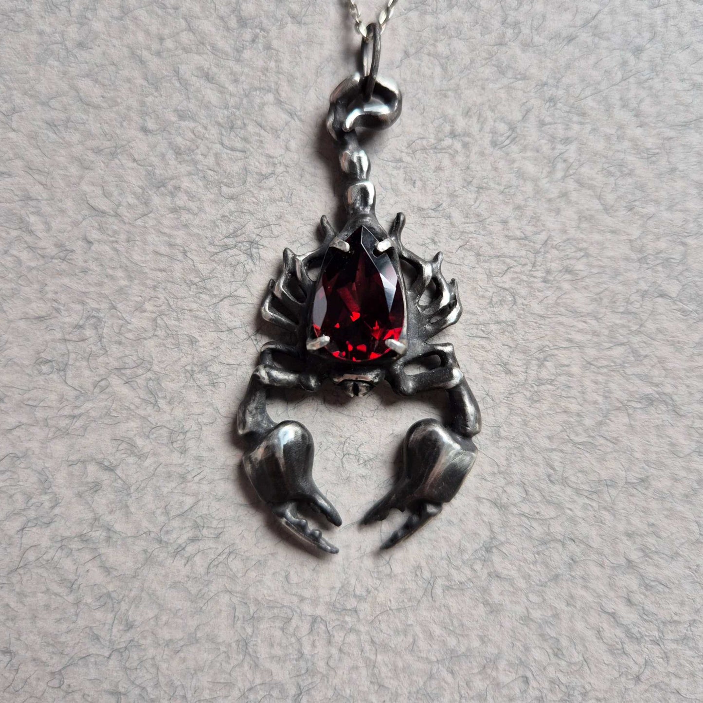 Dragonblood Scorpion pendant with a faceted garnet, handmade witchy talisman